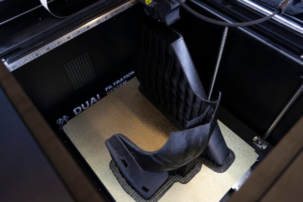 High-tech Tiertime UP600 3D Printer in action, crafting intricate designs with precision, featuring advanced software compatibility and a sleek, modern design for professional manufacturing applications